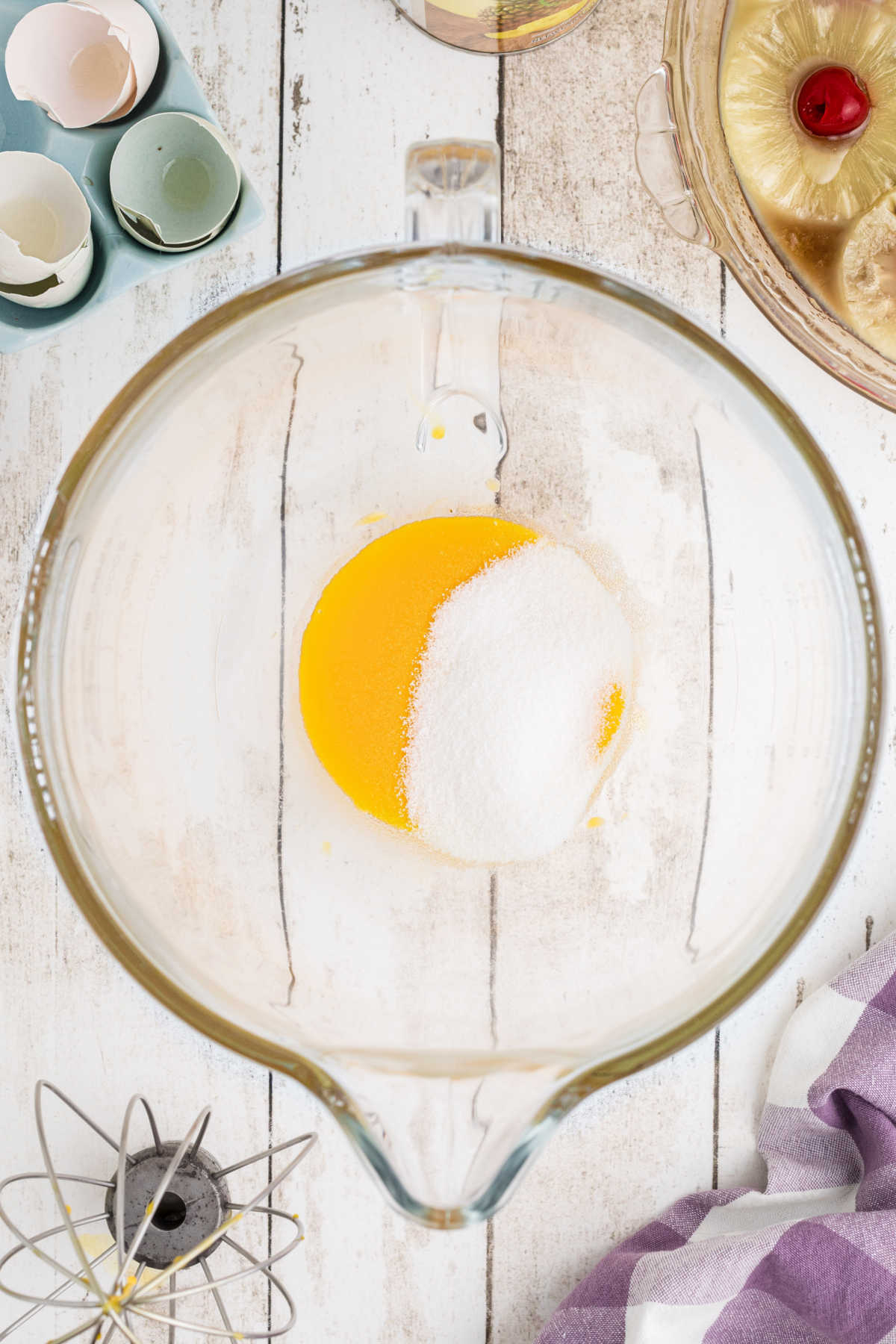Sugar being added to beaten eggs.