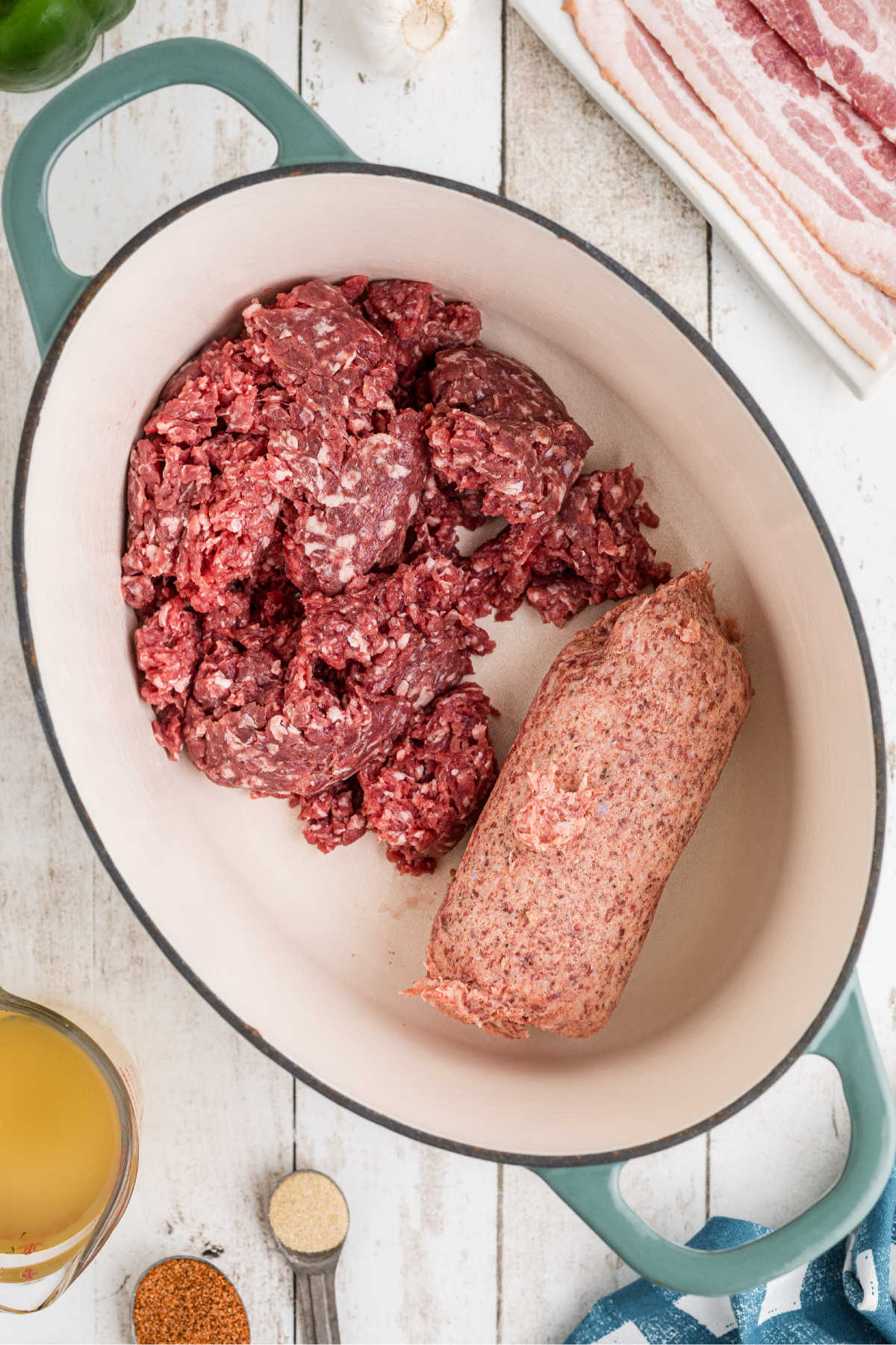 Ground beef and breakfast sausage in a large Dutch oven pot.