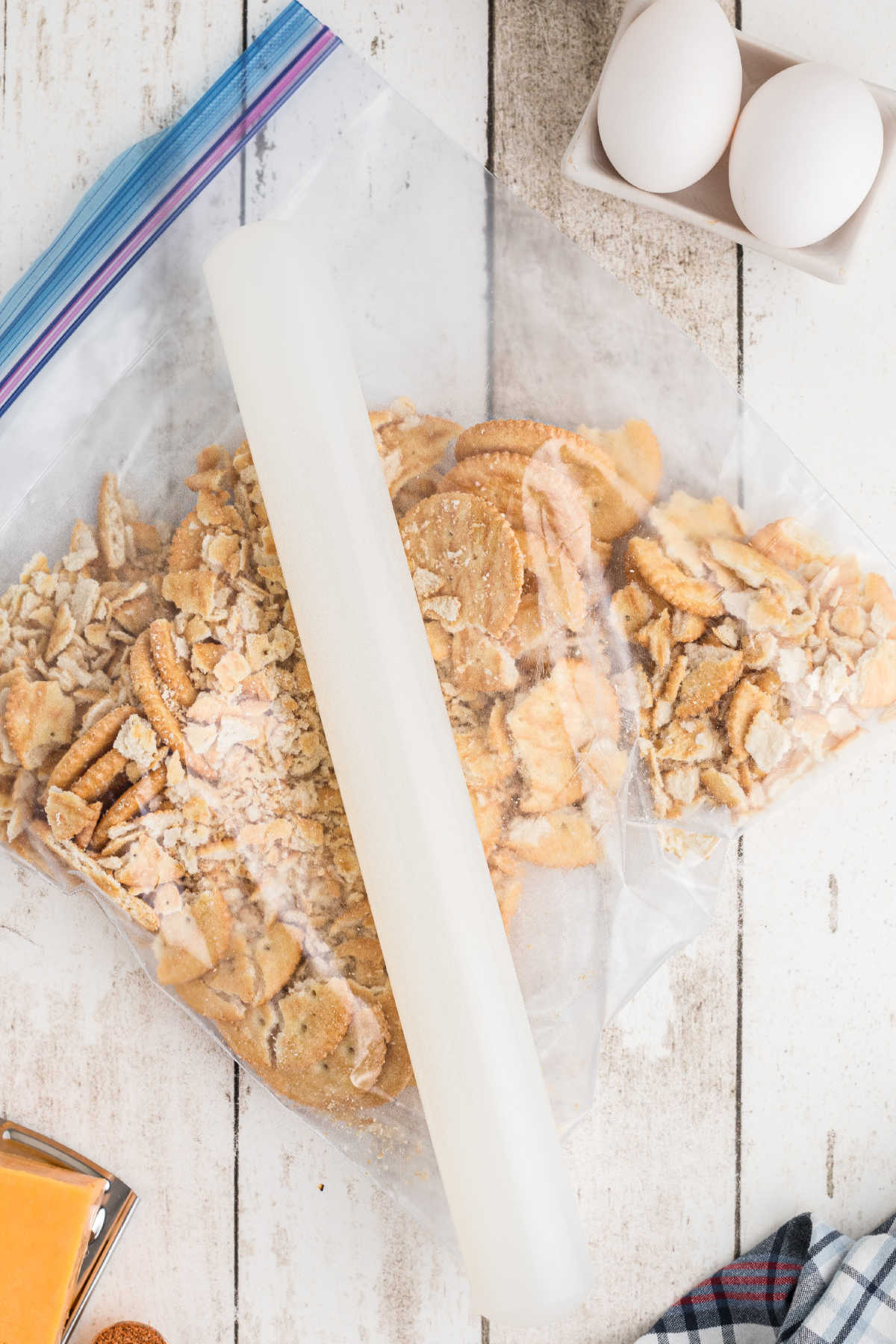 Buttery biscuits being crushed with a rolling pin.