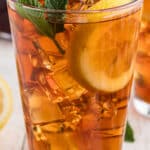 A long image of a glass of sweet tea with ice, lemon and mint. There's text overlay for pinterest.