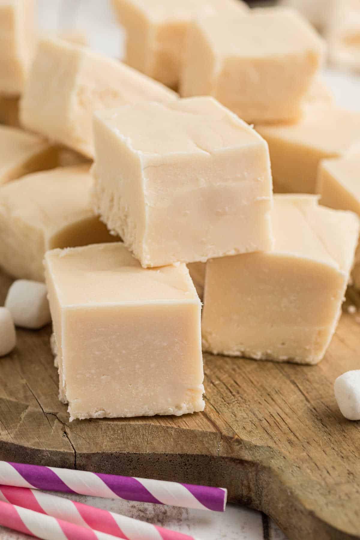 A pile of vanilla fudge on a wooden board.