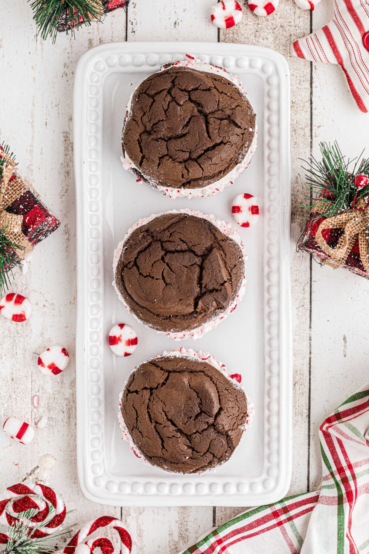 An overhead shot of a plate with 3 Christmas Whoopie Pies on it.