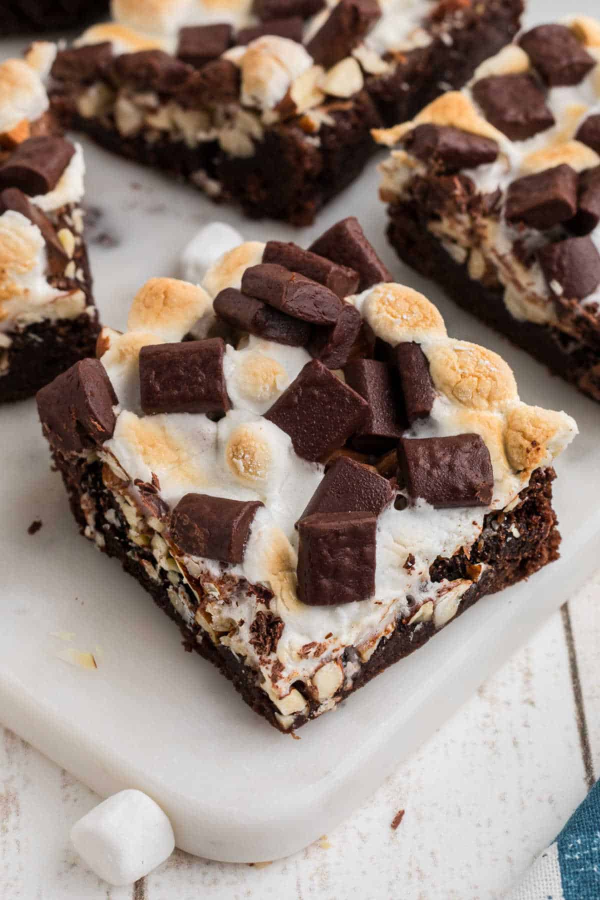 Close up of a rocky road brownie on a board.