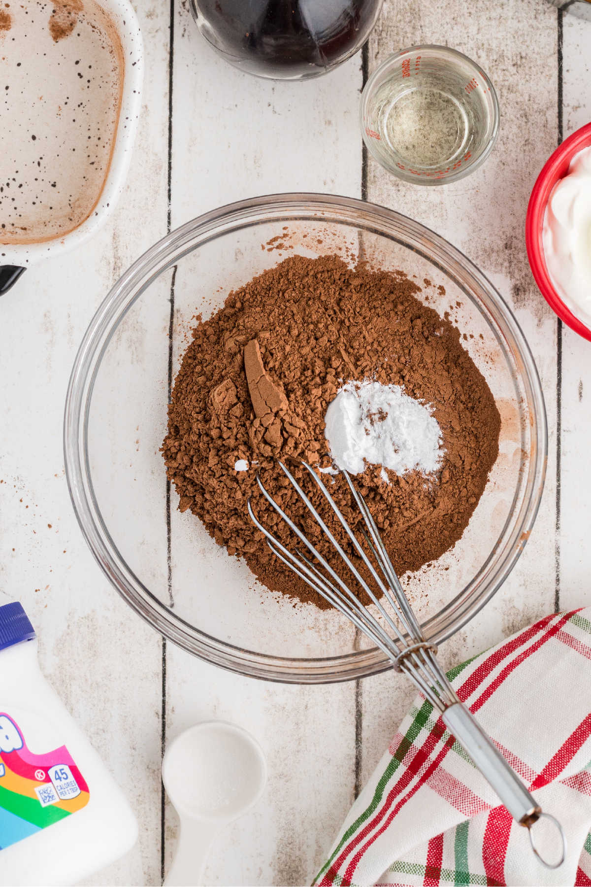 A mixing bowl with cocoa powder and baking soda about to be mixed.