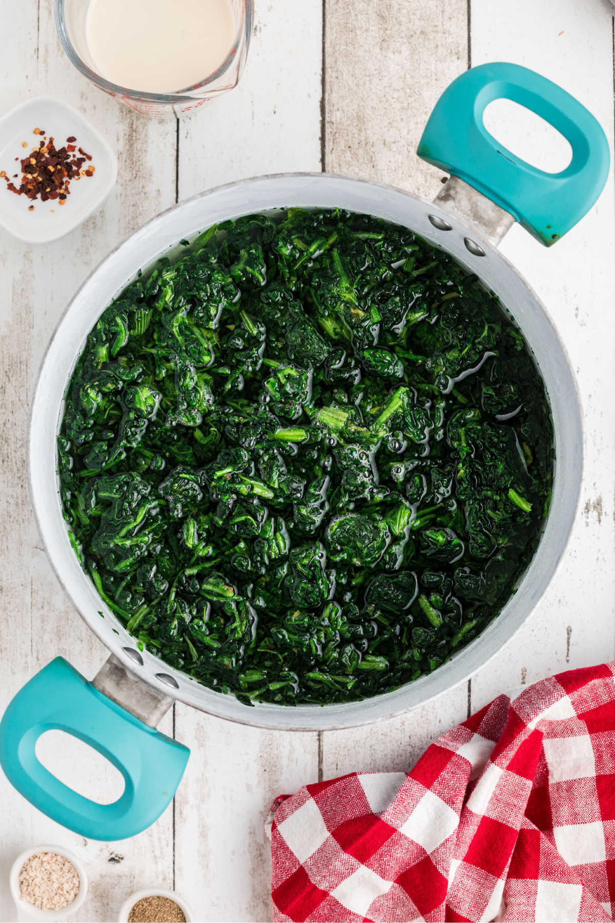 A large pot of spinach being cooked.