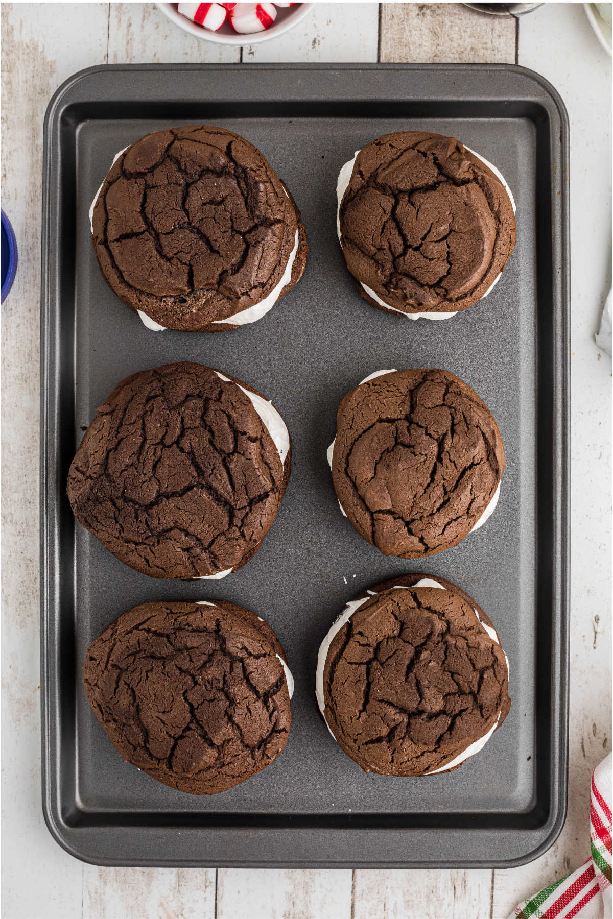 Cookies placed on top of topped cookies, to make a whoopie pie.