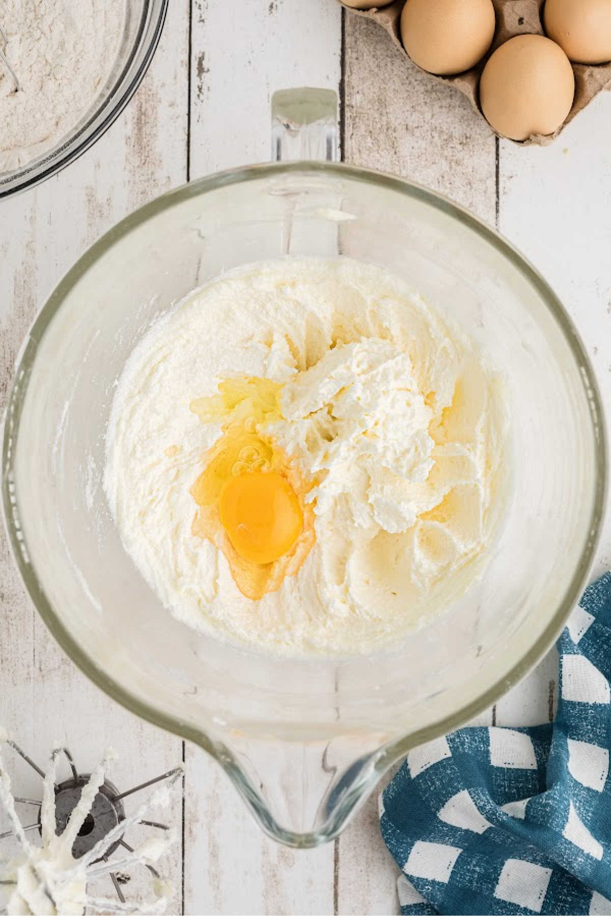 Eggs being added to a batter.