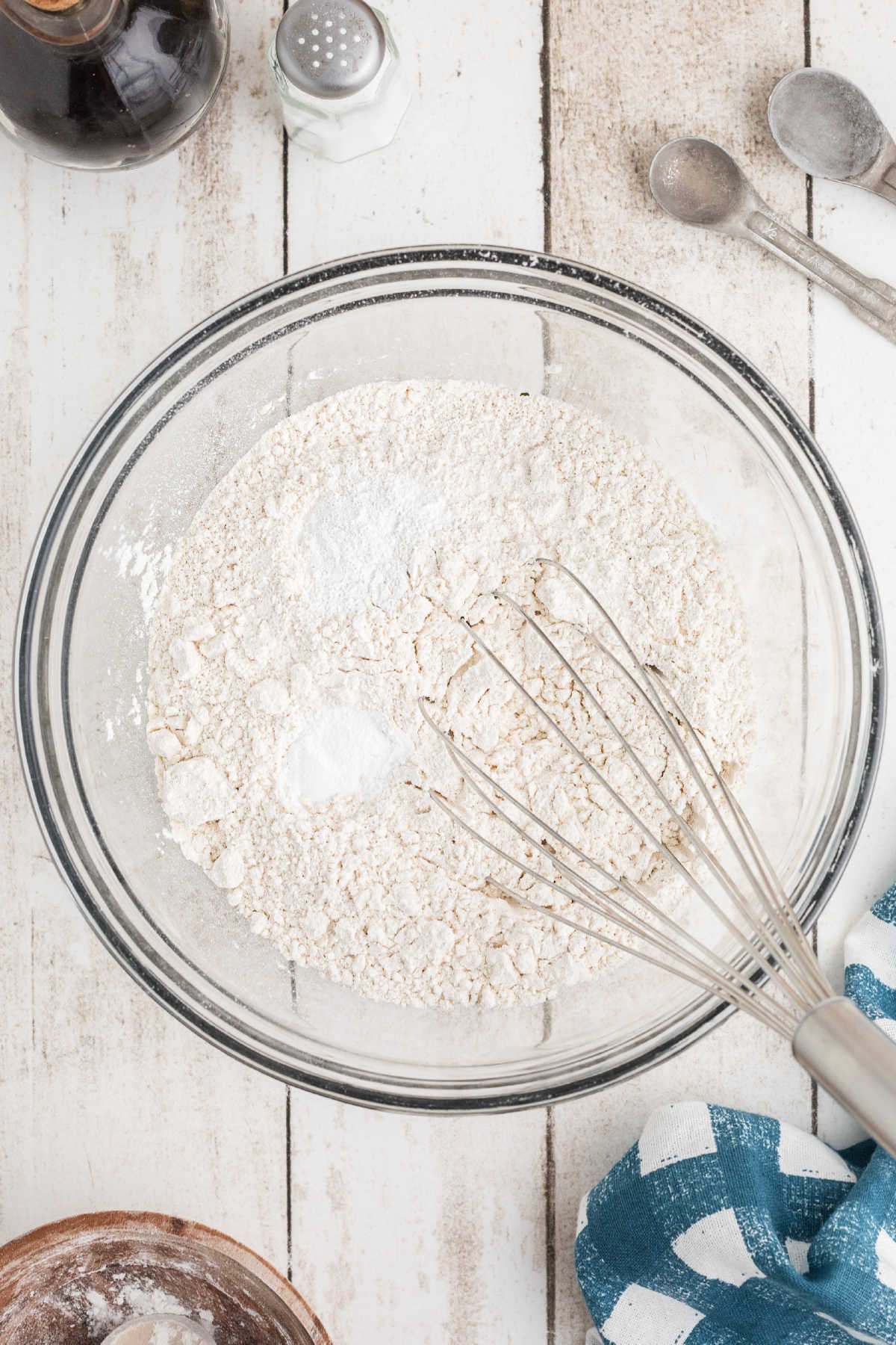 Flour and baking soda being whisked together.