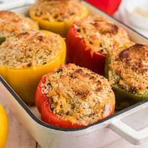 Baking dish full of stuffed bell peppers.