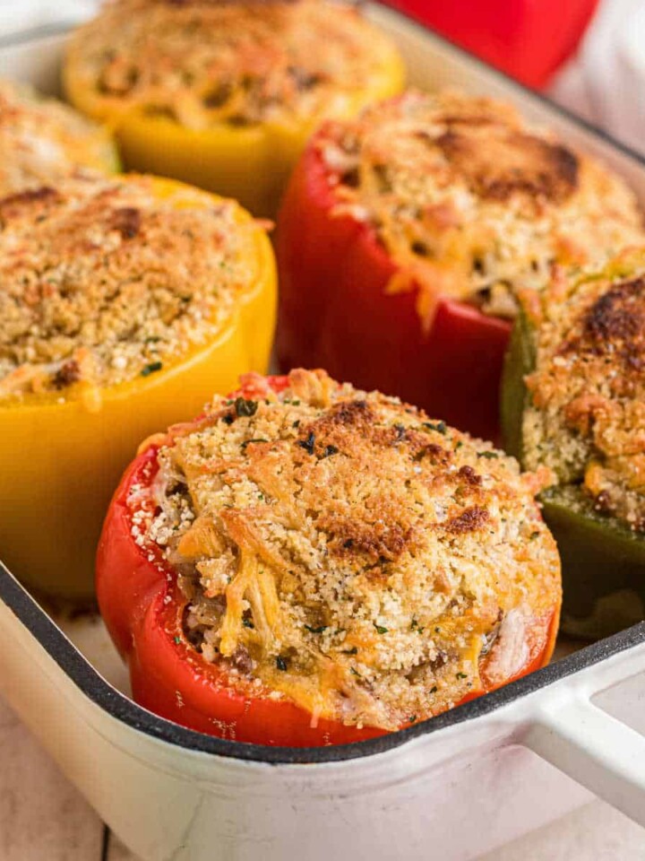 Baking dish full of stuffed bell peppers.