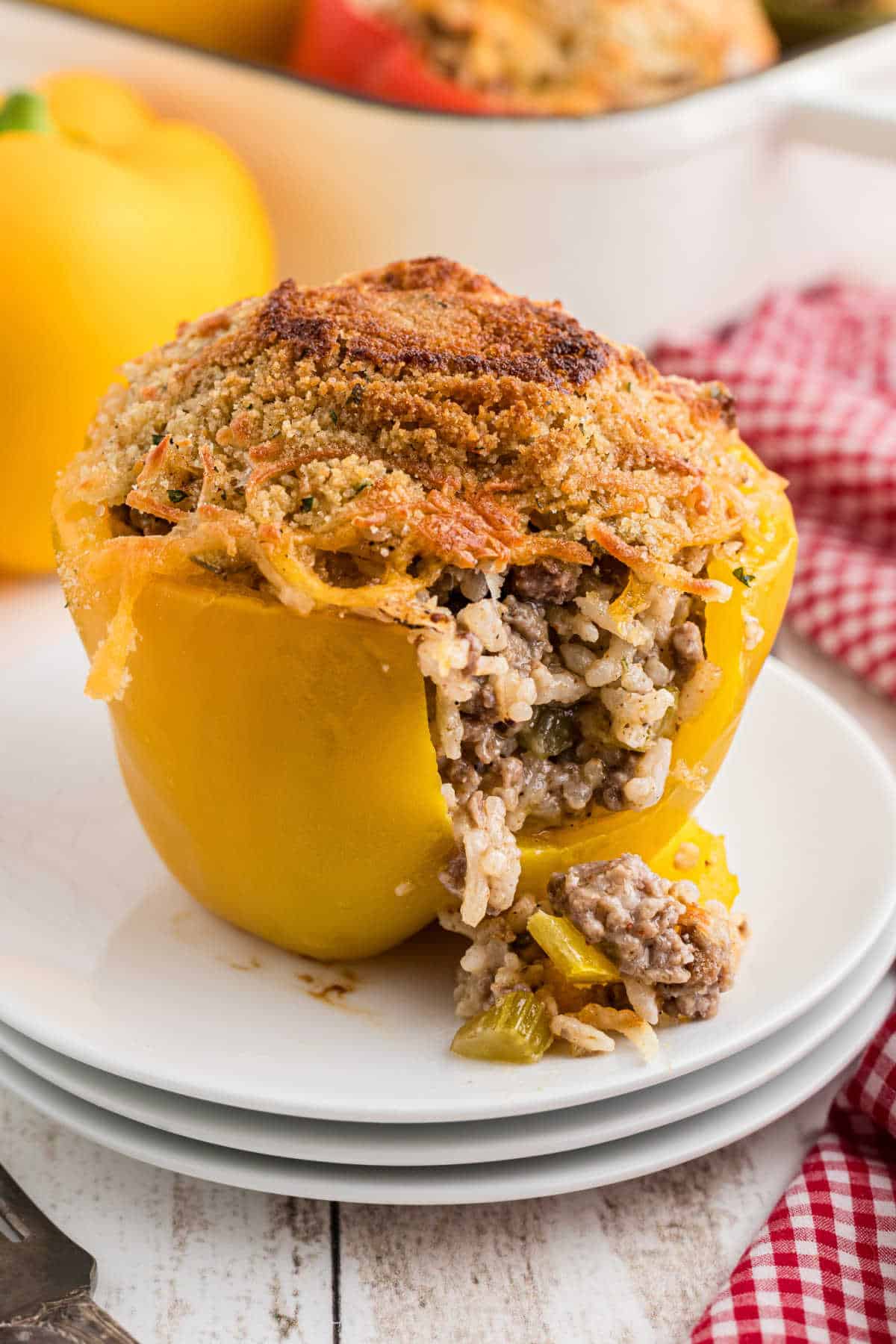 A stuffed bell pepper with a piece take from the front.