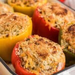 A long image showing stuffed bell peppers close up with text overlay for pinterest.