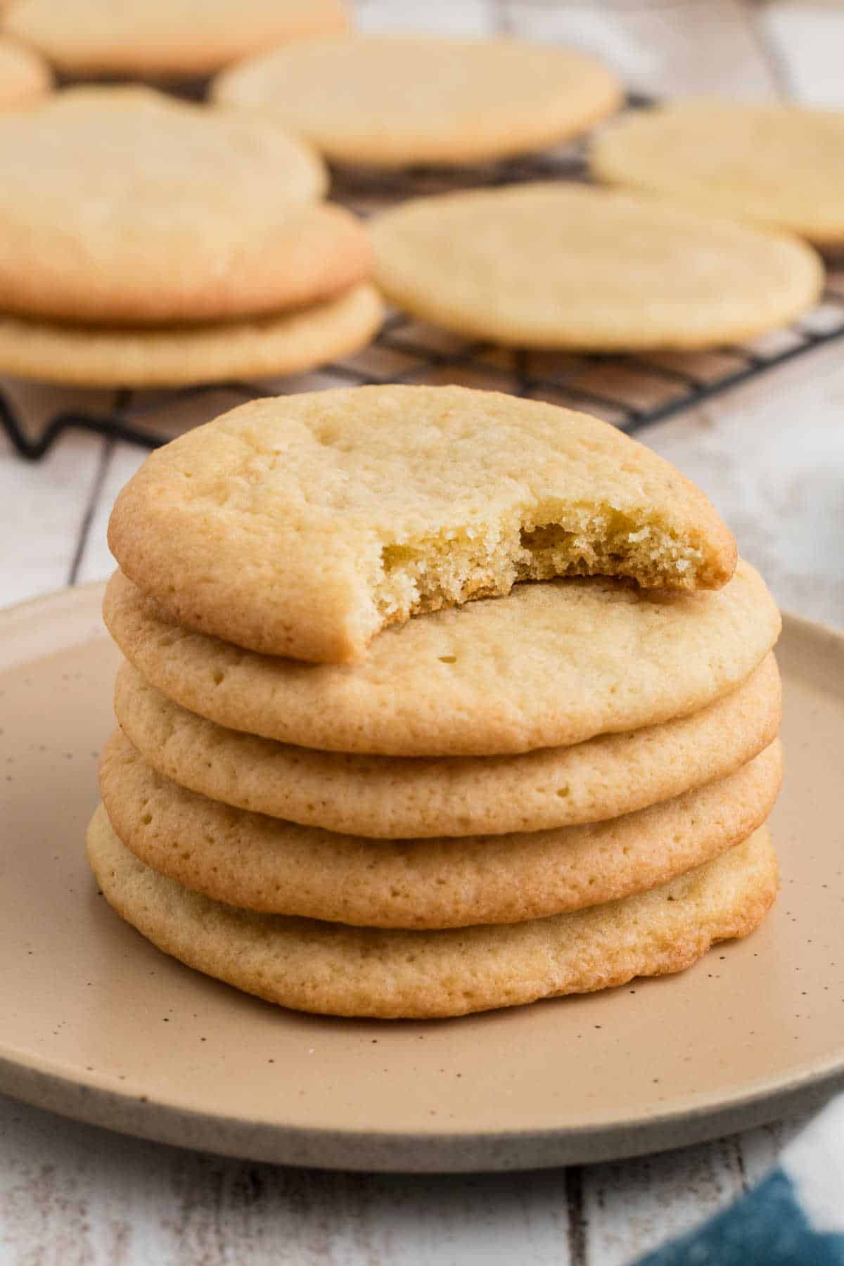 A stack of southern tea cakes, with the top one having a bite missing.