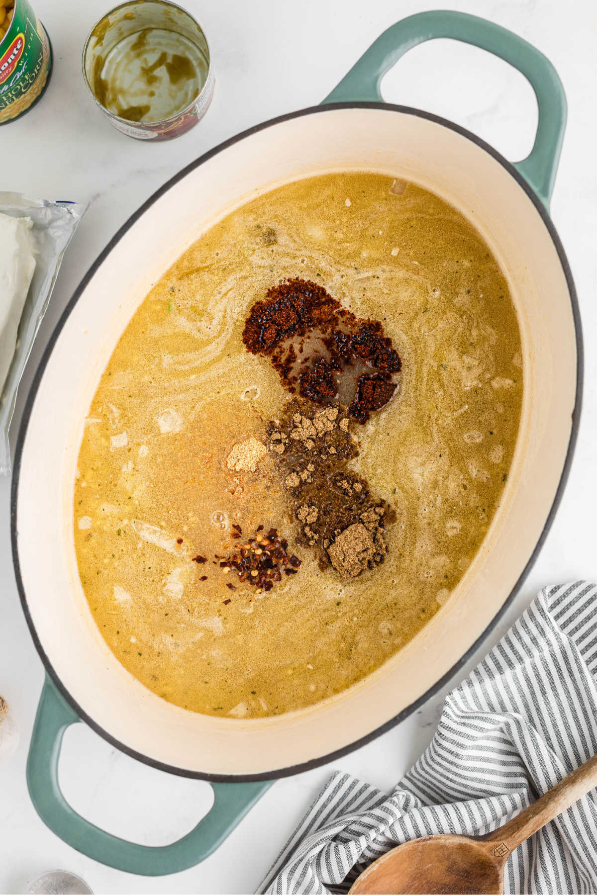 A large Dutch oven with broth and seasonings added.