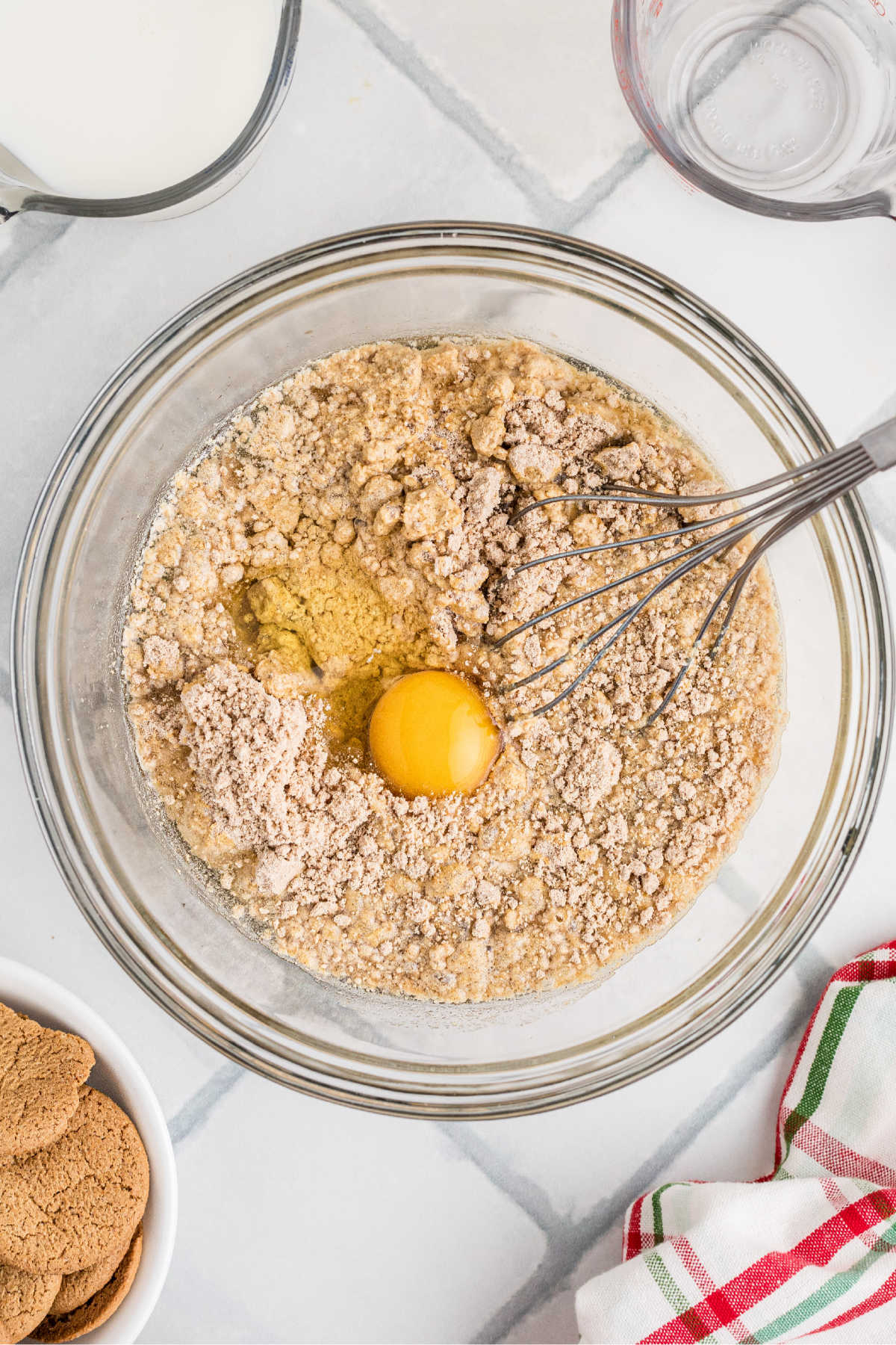 Cake mix eggs and water in a glass mixing bowl.