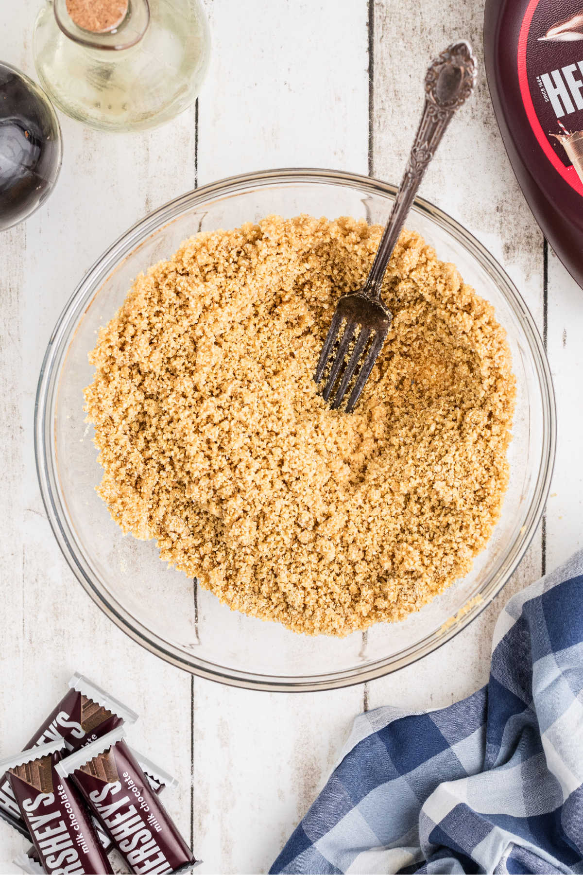 A large mixing bowl filled with Graham cracker crumbs and butter.