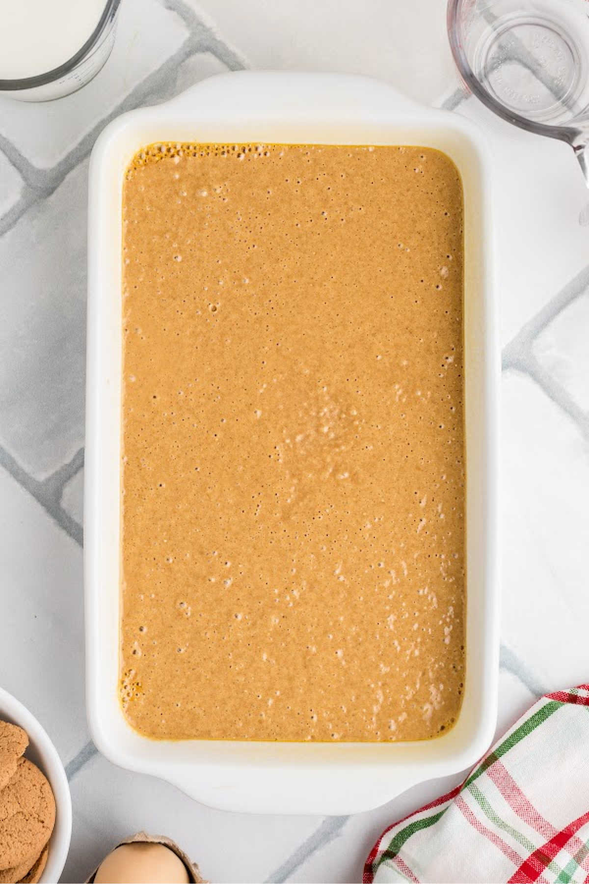 Gingerbread batter poured into a loaf pan.