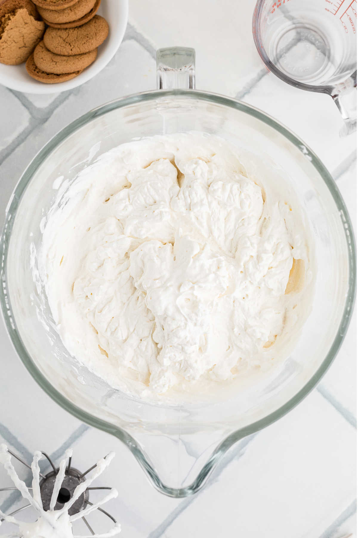 A large mixing bowl with whipped cream.