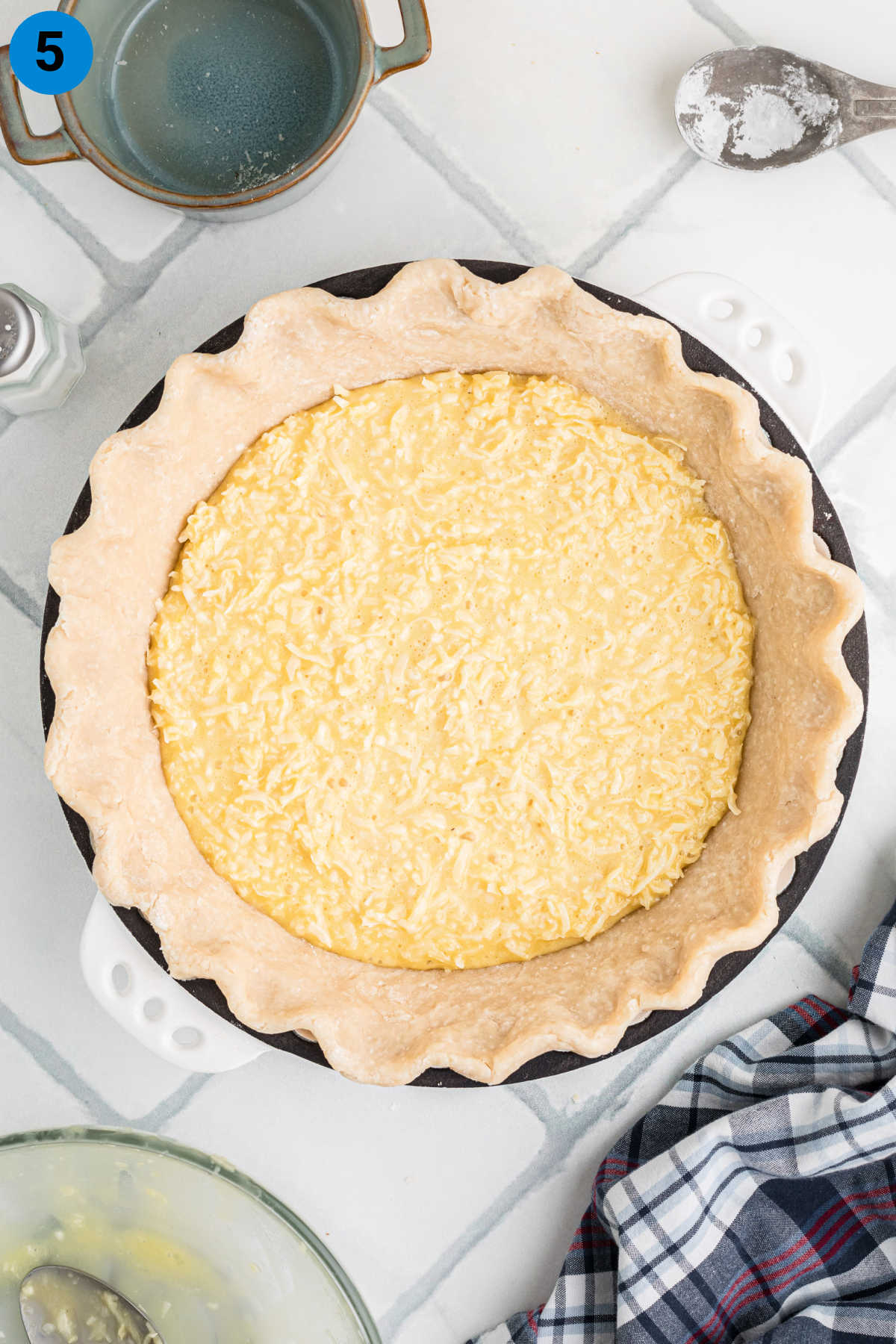 Coconut pie filling in a pie crust ready for baking.