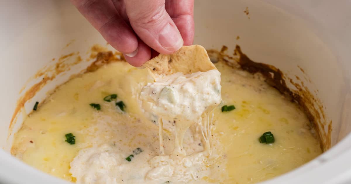 Close up of a hot crab dip made in a slow cooker.