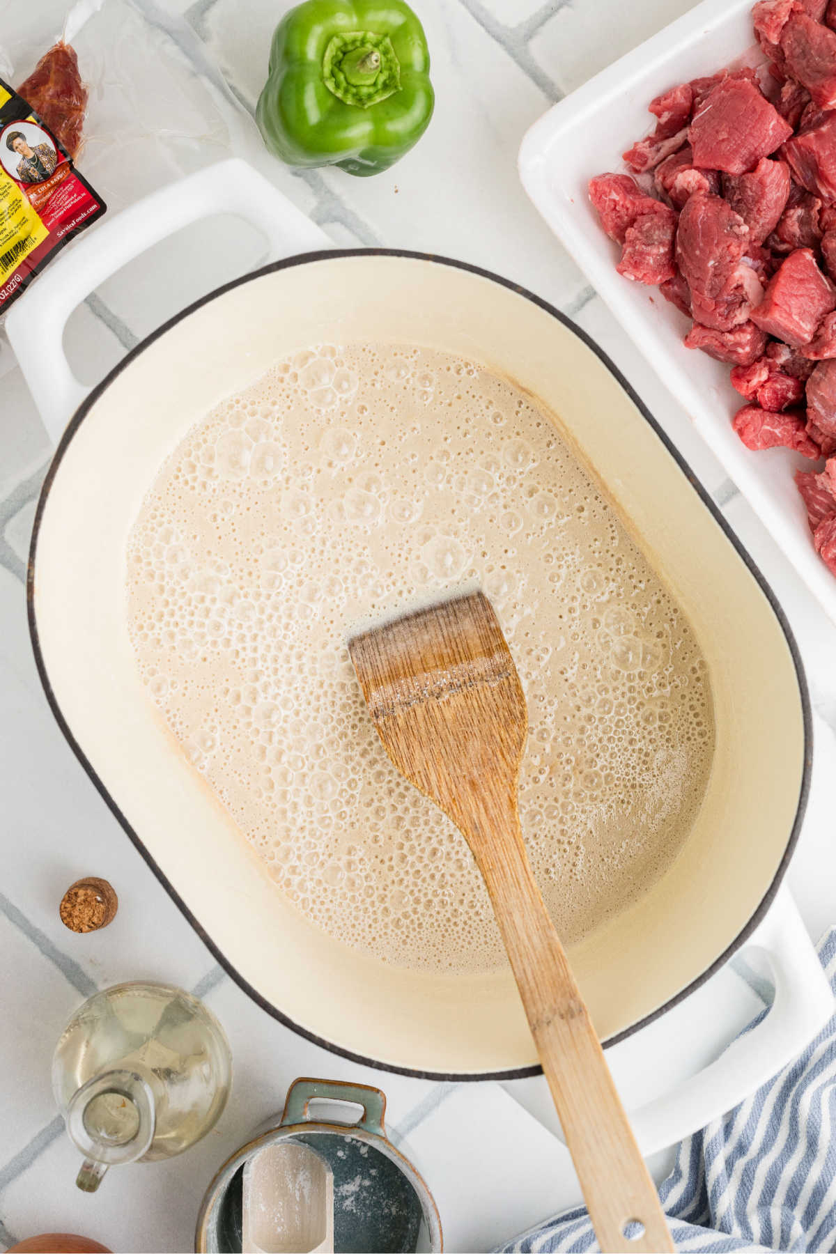 A large Dutch Oven with oil and flour cooking.