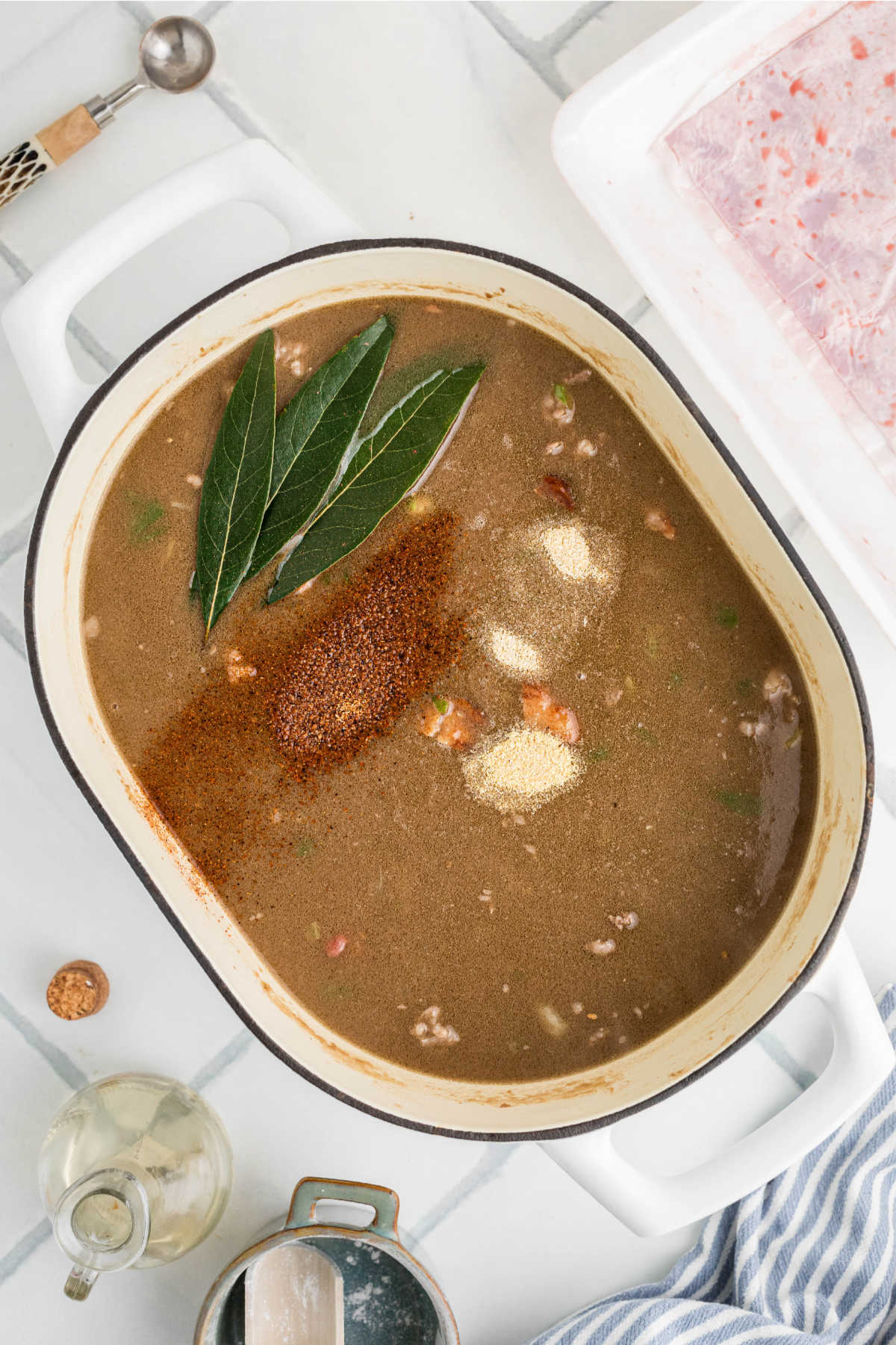 Seasonings and other ingredients added to a pot of gumbo.