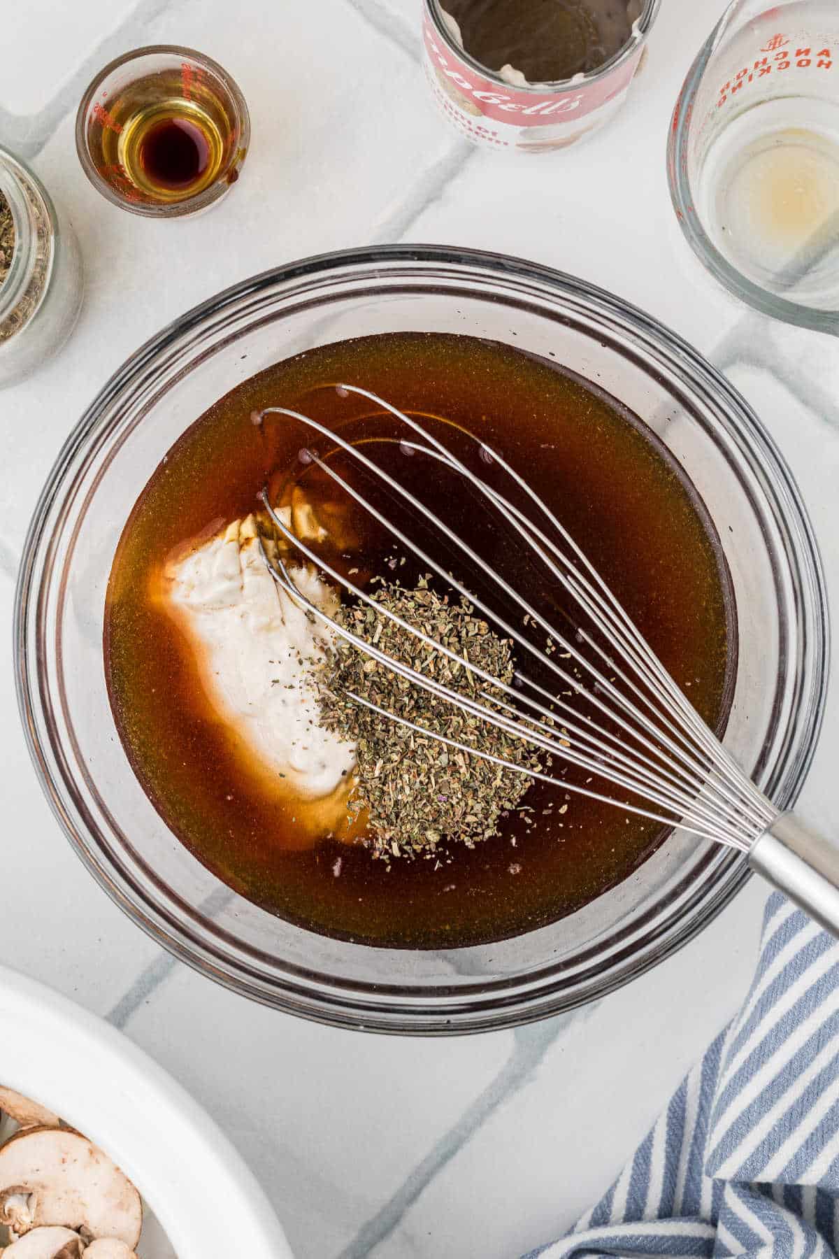 A large mixing bowl filled with beef broth and seasoning.