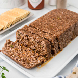 A loaf of hog head cheese, sliced.