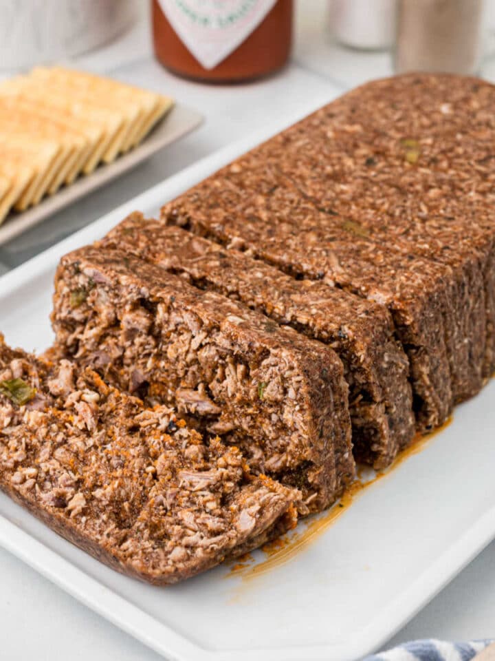 A loaf of hog head cheese, sliced.