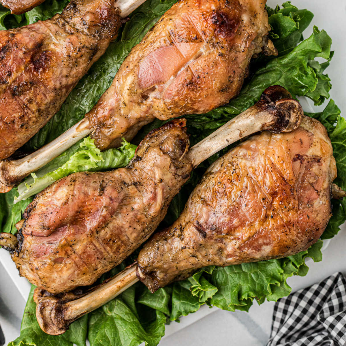Southern Baked Turkey Legs on a bed of lettuce.