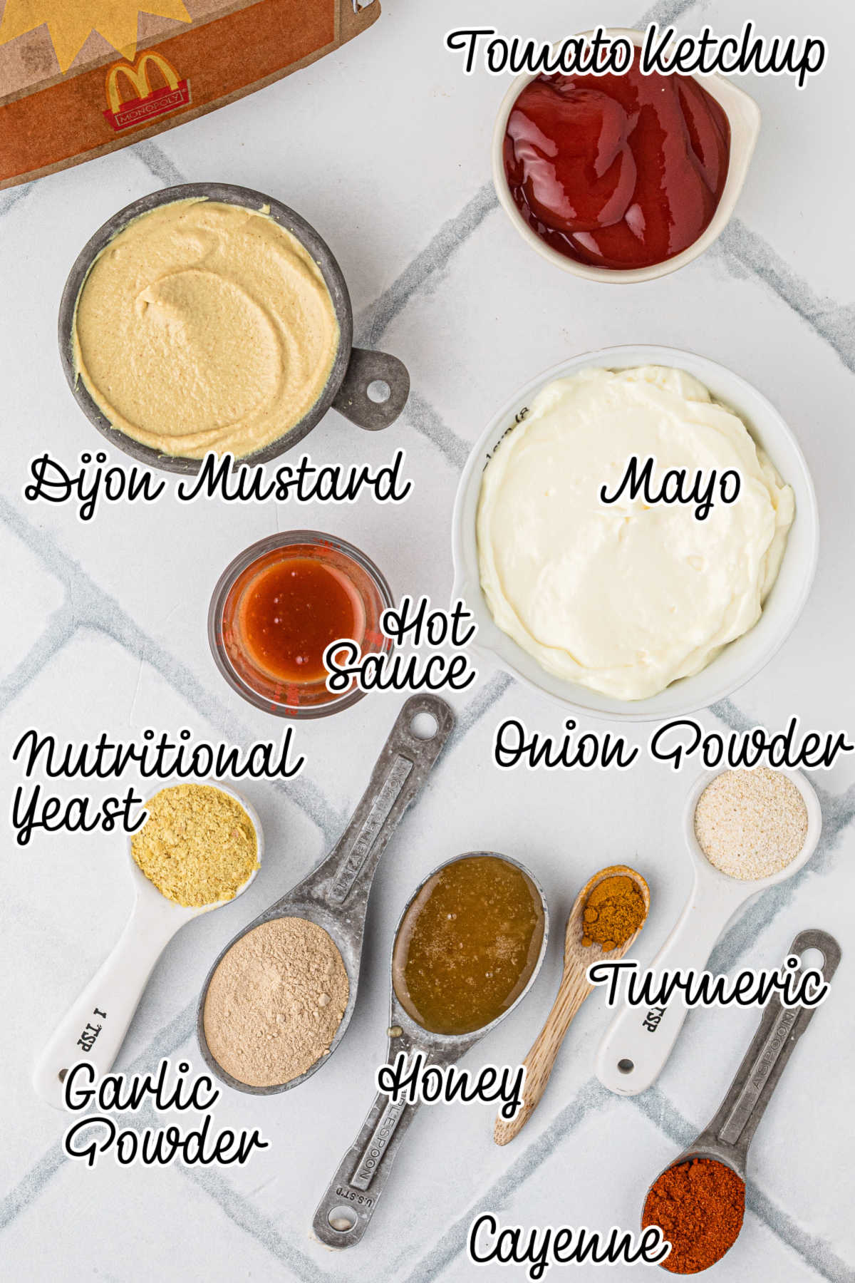 Ingredients needed to make a Cajun Sauce recipe, all laid out and text overlaid.