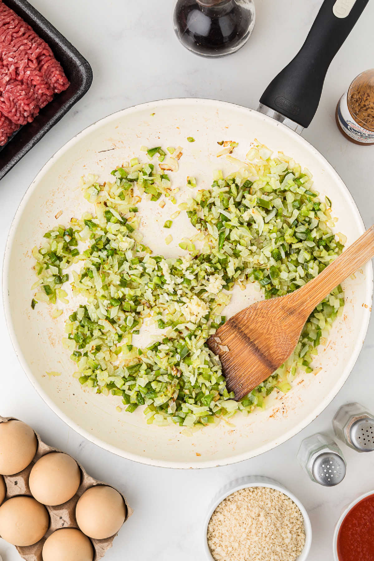 A large skillet cooking some veggies.
