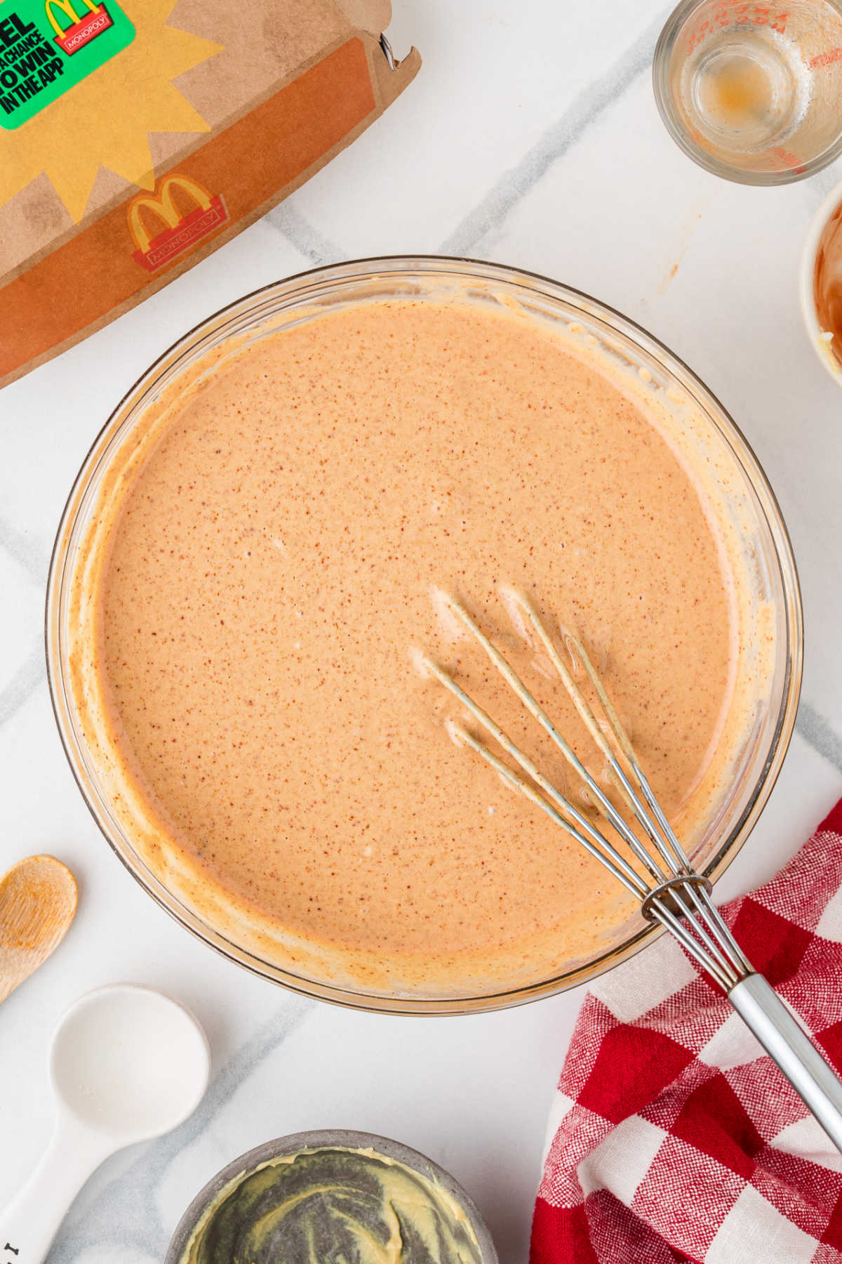 A large bowl of Cajun Sauce, with a whisk.
