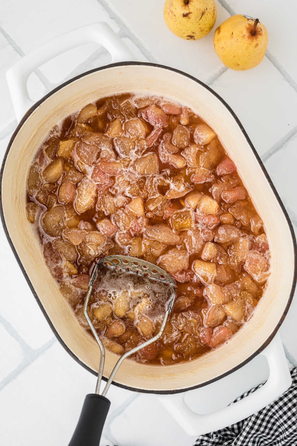 A large pot with pears that have been cooked down.