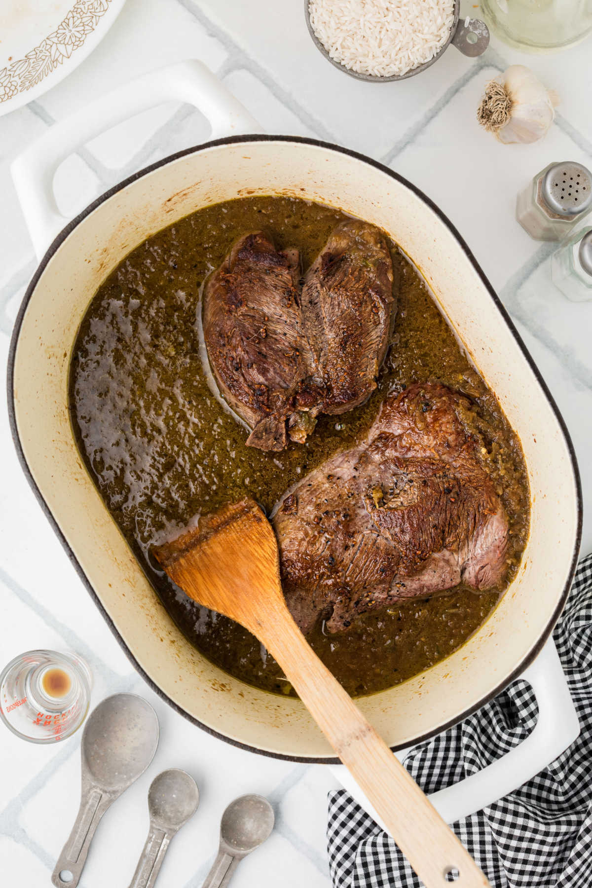 Overhead shot of roast being added to a large pot.