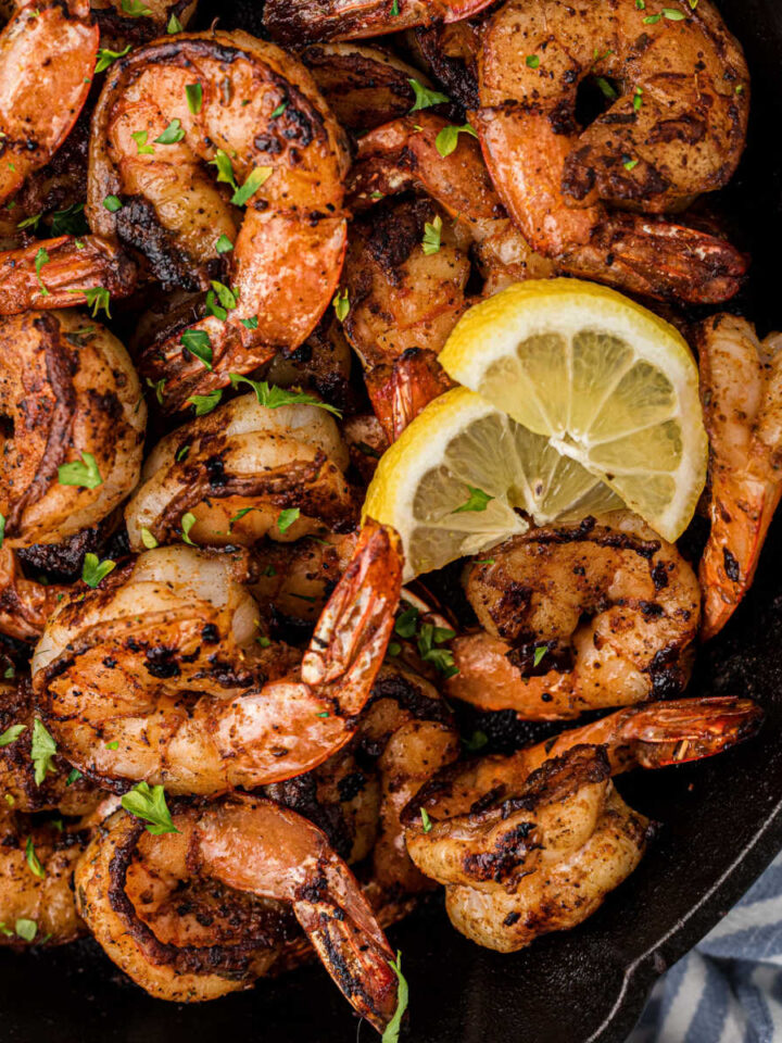 Close up of a cast iron skillet with blackened shrimp.