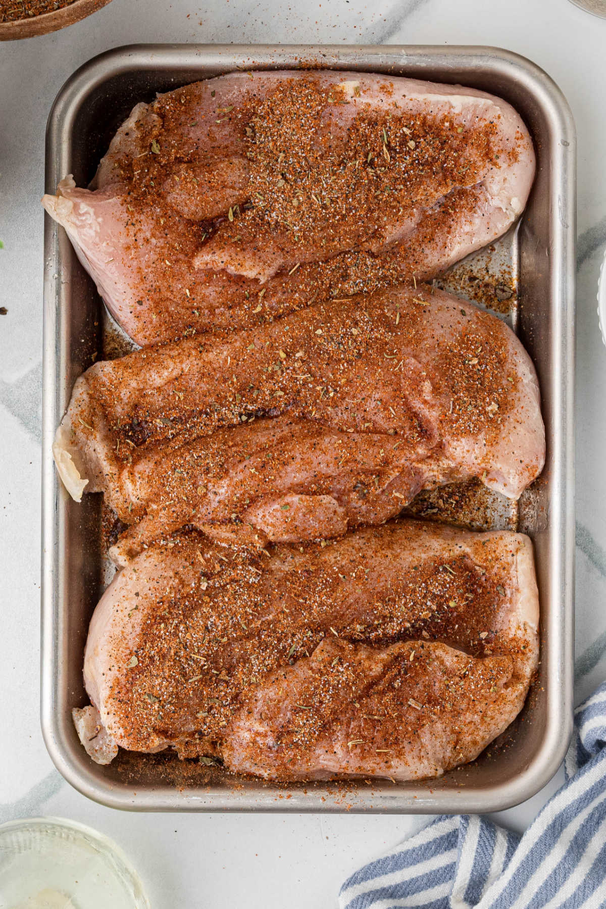 Chicken coated in blackened seasoning.