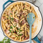 A large skillet filled with Cajun Chicken and Sausage pasta.
