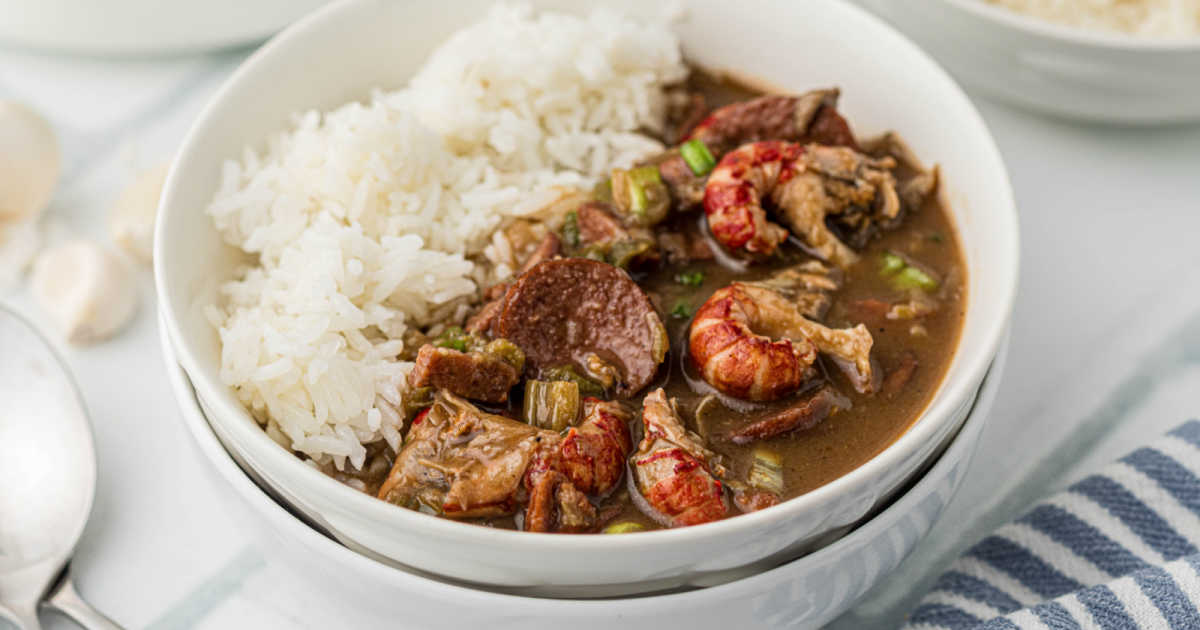 Close up of a bowl of crawfish gumbo, with rice.
