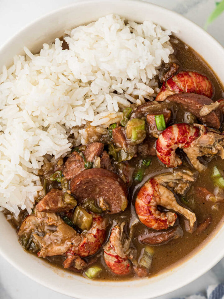 An overhead close up image of a bowl full of crawfish gumbo and rice.