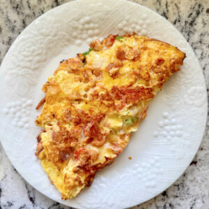 A delicious looking crawfish omelette on a white plate.