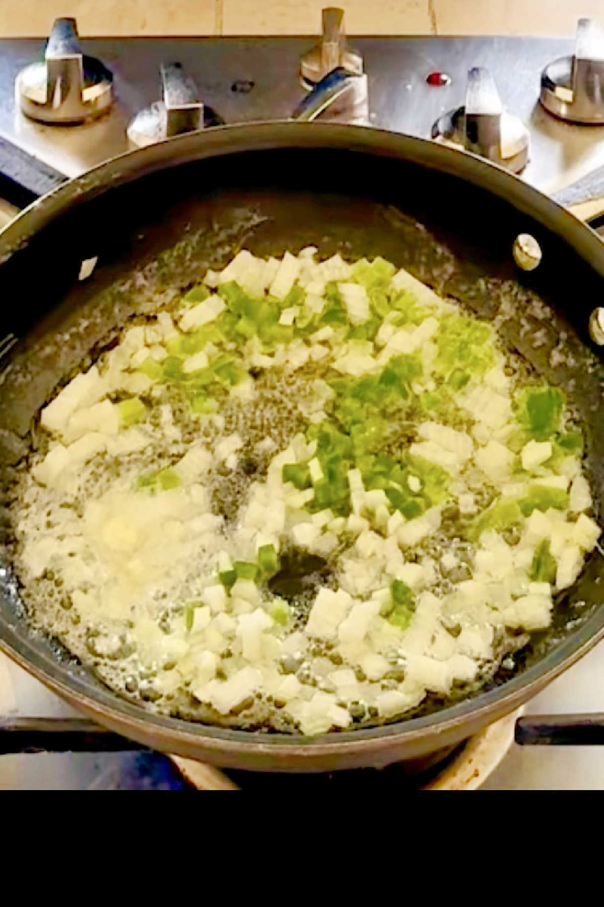 Onions, bell pepper and celery (otherwise known as the Cajun holy trinity) added to butter in a skillet.