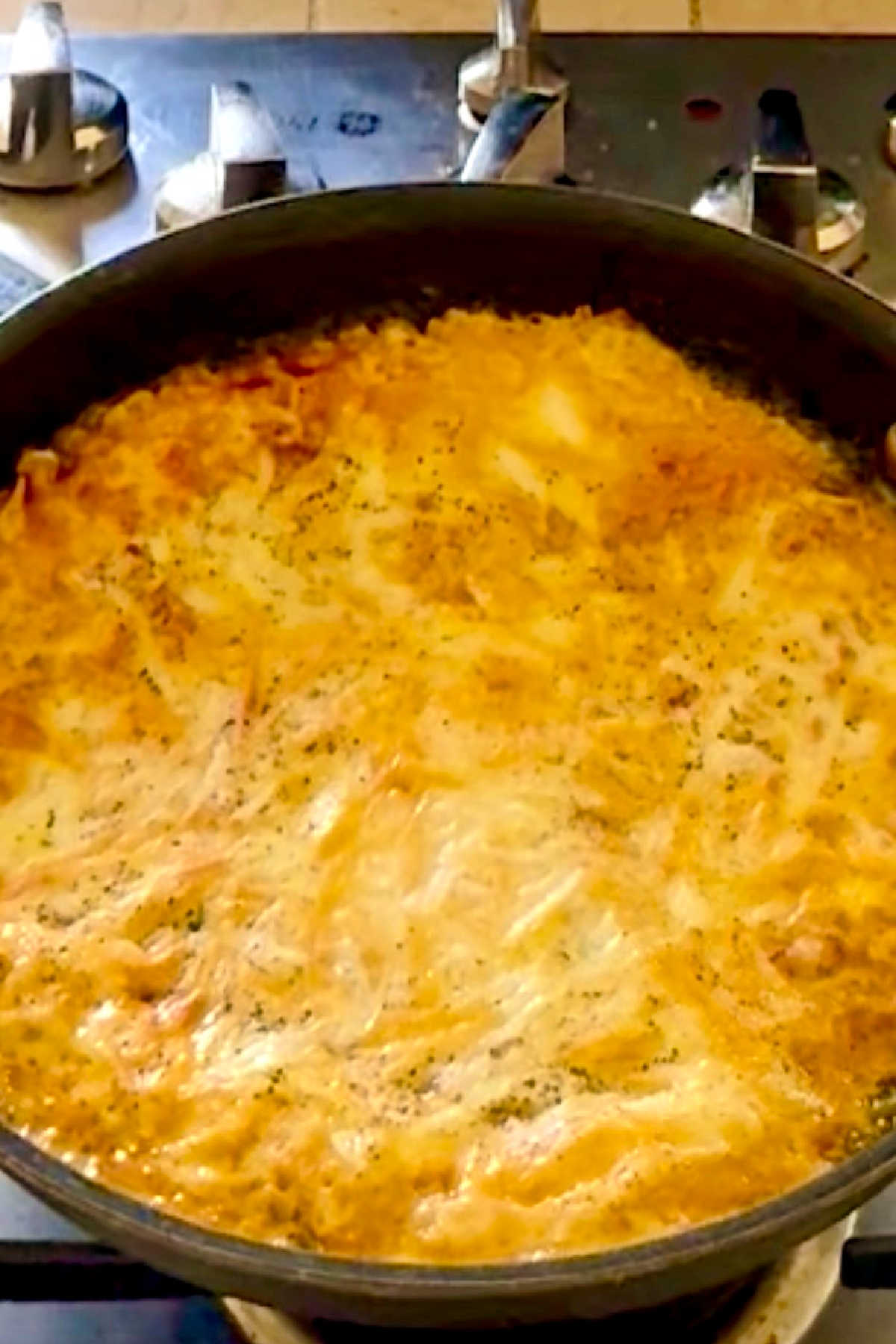 A puffy looking omelette in a skillet.