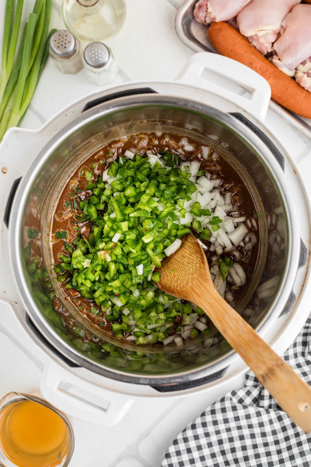 Trinity of onions, bell peppers and celery added to a roux in an instant pot.