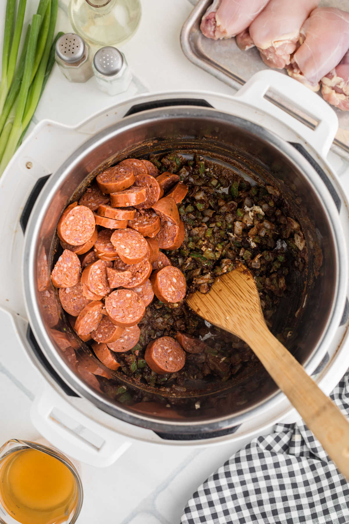 Sliced sausage added to an instant pot.