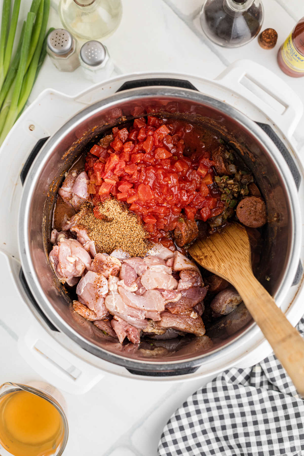 Diced tomatoes, chicken and seasonings added to an instant pot.